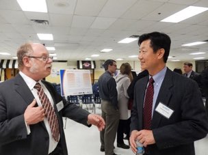 Sully District Transportation Commissioner Jeff Parnes (on left) makes a point while Young Ho Chang, a VDOT consultant, listens